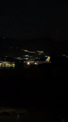 Night aerial view of a Thai airport with plane on tarmac