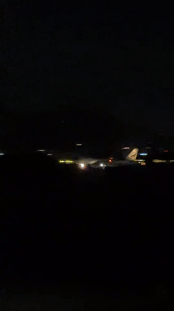 Night aerial view of a Thai airport with plane on tarmac