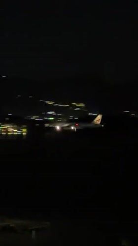 Night aerial view of a Thai airport with plane on tarmac