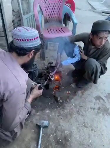 Street welders repair metal components in Kandahar workshop
