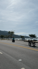 Motorcyclists travel coastal road in Đà Nẵng amid light traffic