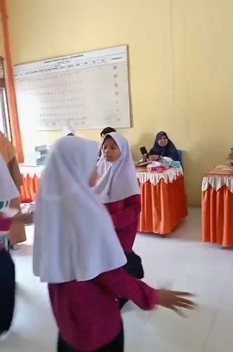 Students perform synchronized dance routines in Keudekrueng, Indonesia