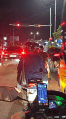 Motorcycle rider waits at red light in Kuta traffic