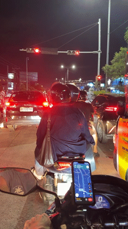 Motorcycle rider waits at red light in Kuta traffic