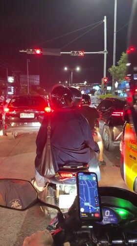 Motorcycle rider waits at red light in Kuta traffic
