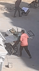 Carts and foot traffic on a busy paved outdoor surface