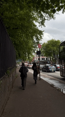Urban street scene with pedestrians, cyclist, and double-decker bus