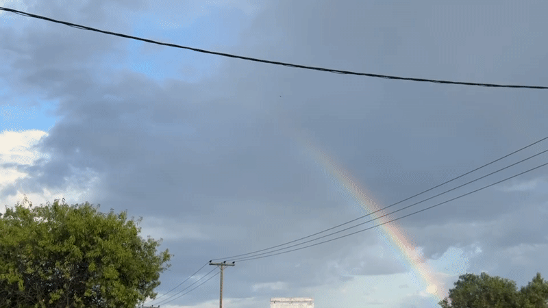 Rainbow appears over Γερακινή, Greece amid cloudy afternoon skies