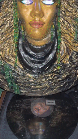 Ornate golden Balinese face sculptures with glowing blue eyes