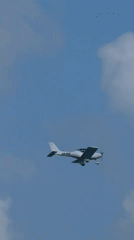 Surfers, skaters, and a small plane on a Netanya summer morning