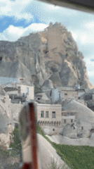 Tourists capture Cappadocia's unique landscape from tour bus