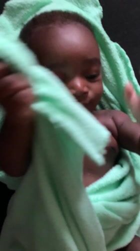 Infant wrapped in green towel observed in Nigeria