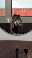 Woman takes bathroom selfie in Mengwi, Indonesia