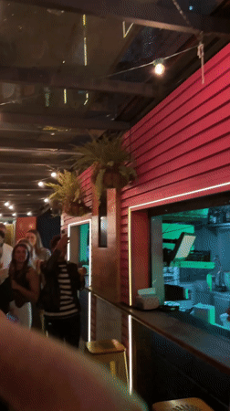 Young musician plays red guitar in São Paulo chair