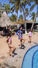 Three females perform poolside dance routine in Porlamar resort