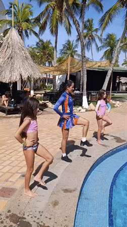 Three females perform poolside dance routine in Porlamar resort