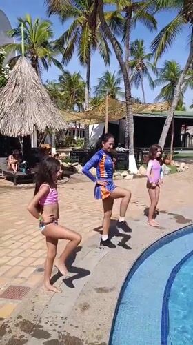 Three females perform poolside dance routine in Porlamar resort