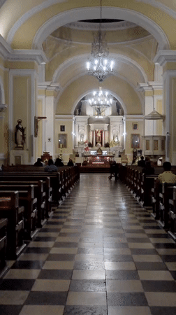 Late-night religious devotion documented at Catholic church in Tacna