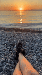Sunset on Batumi's Black Sea beach, people on shore and water