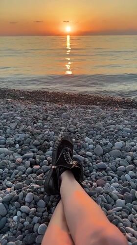 Sunset on Batumi's Black Sea beach, people on shore and water