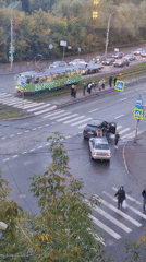 Autumn traffic and trams at a wet Izhevsk intersection