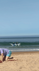 Surf and beach activity at Costa da Caparica on a sunny morning