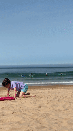 Surf and beach activity at Costa da Caparica on a sunny morning