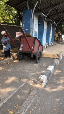 Morning traffic and street activity along a Gelam road