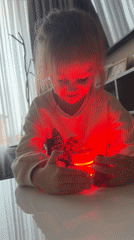 Girl plays with light-up spinning top in Varna, Bulgaria