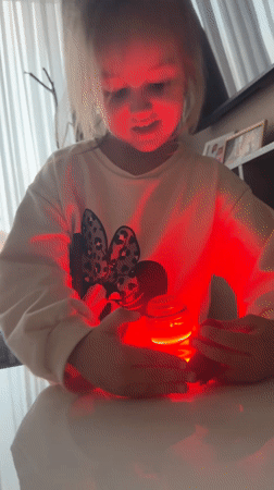 Girl plays with light-up spinning top in Varna, Bulgaria