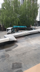 Early morning construction delivery observed from rooftop viewpoint