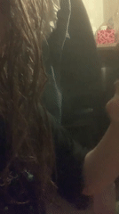 Person vaping indoors in dimly lit Sinyavino setting