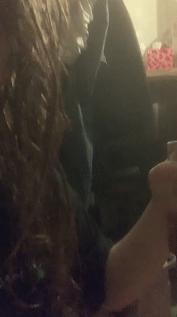 Person vaping indoors in dimly lit Sinyavino setting
