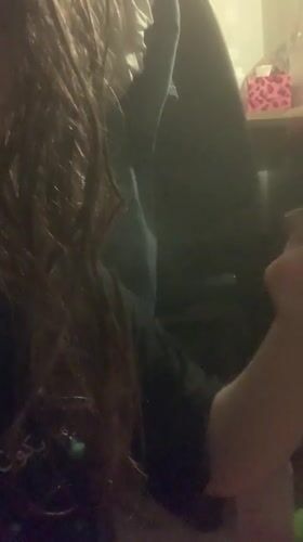 Person vaping indoors in dimly lit Sinyavino setting