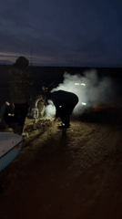Evening outdoor gathering around fire in rural Russia