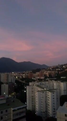 Witness documents twilight over Caracas hillside neighborhoods