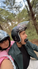 Moped riders explore forest paths in rural Vietnam
