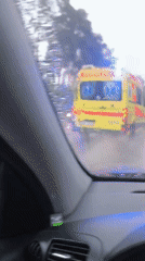 Driver records ambulance passing during rainy weather in Latvia