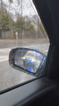Driver records ambulance passing during rainy weather in Latvia