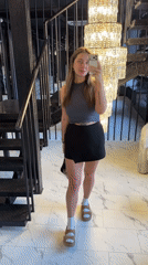 Woman takes selfie on ornate staircase in Moscow