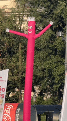 Aerial silk performer and inflatable tube man at Munich outdoor event