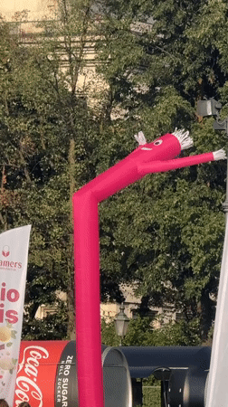 Aerial silk performer and inflatable tube man at Munich outdoor event