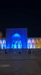 Samarkand's Registan Square glows during a summer evening light show