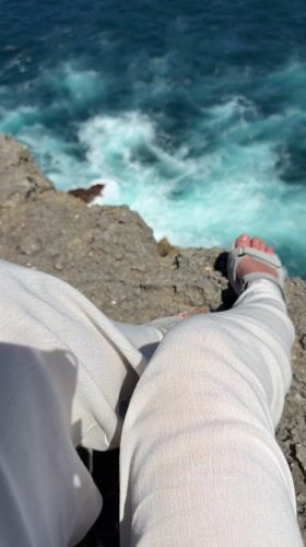 Morning cliff sitting captured at Nusa Penida ocean viewpoint
