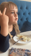 Young girl eating and puzzle-solving captured in morning hours