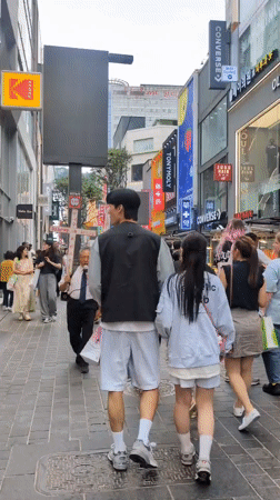 Morning street life unfolds in busy Seoul commercial district