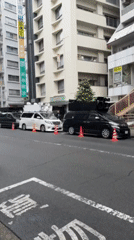 Vehicles parked with traffic cones on Suginami City street