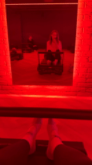 Red-lit Pilates studio scene captured in Riga