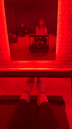 Red-lit Pilates studio scene captured in Riga