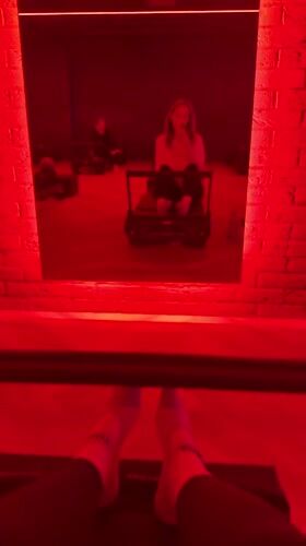 Red-lit Pilates studio scene captured in Riga